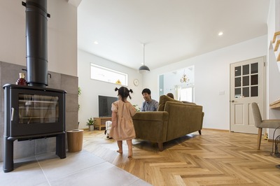 リビングはこだわりのヘリンボーンの床。ダイニングはタイルに切り替えて、住まいが醸し出す二つの表情を楽しんでいる。暖炉は今年の冬から活躍します。