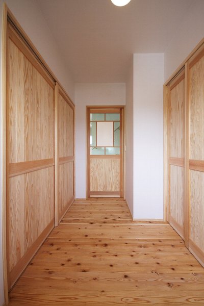 正面の造作建具はすりガラスと透明ガラスを組み合わせ、人の気配を感じながらも直接見えないように工夫したデザインに。 正面の造作建具はすりガラスと透明ガラスを組み合わせ、人の気配を感じながらも直接見えないように工夫したデザインに。