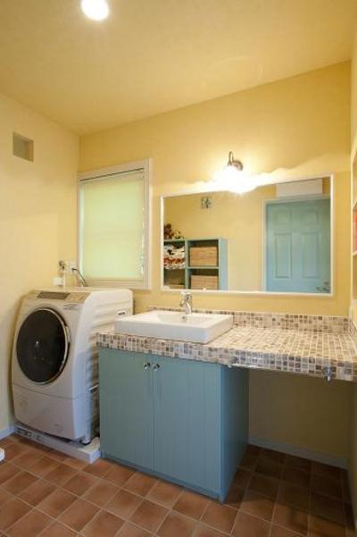 洗面は造作でつくりました。モザイクタイルのベージュと洗面建具のブルーグリーンの色がアクセントになっています。